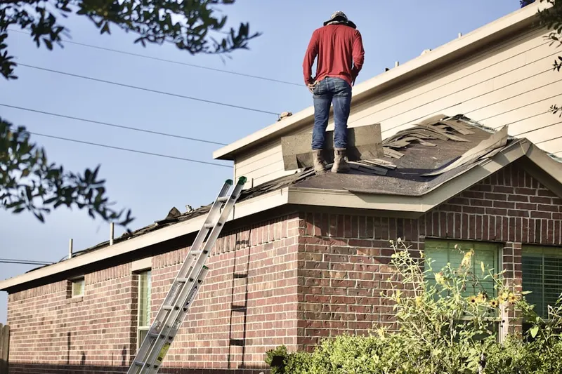 Professional roofer working on a residential roof in Canon